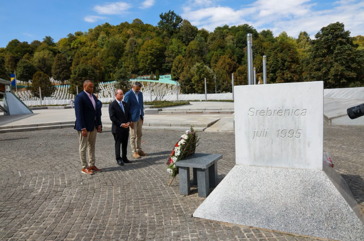 Representatives Veasey and Murphy stand with the head of the Srebrenica Memorial Center at a memorial for victims of the Srbrenica genocide