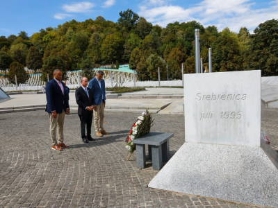 Representatives Veasey and Murphy stand with the head of the Srebrenica Memorial Center at a memorial for victims of the Srbrenica genocide