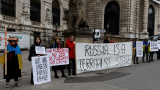 Protestors stand outside Hofburg Palace in Vienna as an OSCE meeting takes place on February  