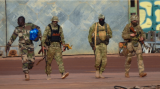This undated photograph handed out by French military shows three Russian mercenaries right in northern Mali 