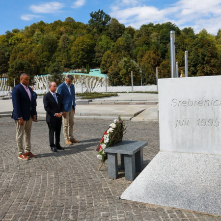 Representatives Veasey and Murphy stand with the head of the Srebrenica Memorial Center at a memorial for victims of the Srbrenica genocide