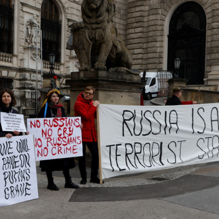 Protestors stand outside Hofburg Palace in Vienna as an OSCE meeting takes place on February  